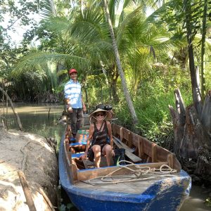 Tourists exploring small coconut canals in Ben Tre