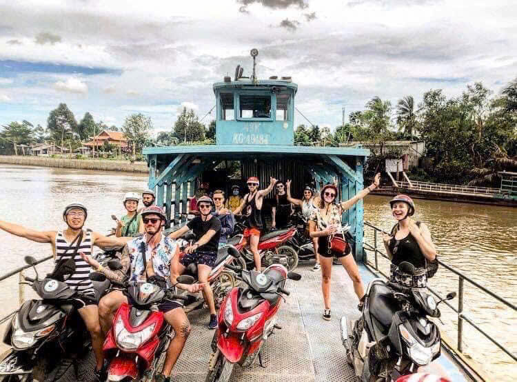 Tourists paddling through small canals in Ben Tre Mekong Delta Vietnam