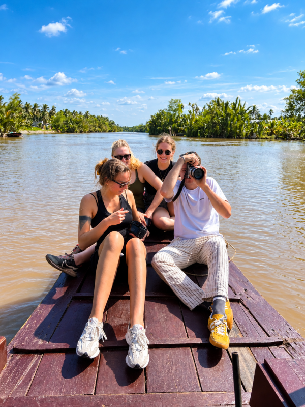 Guests enjoying an authentic Mekong Delta boat experience in Ben Tre